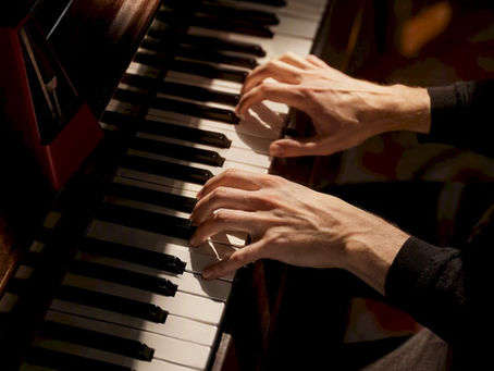 Hands playing a piano polyrhythm