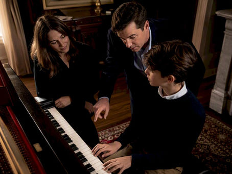 Parent and teacher discussing piano practice exercise