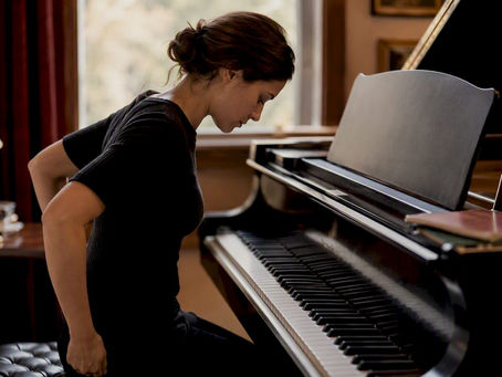 Pianist preparing at grand piano in warm room