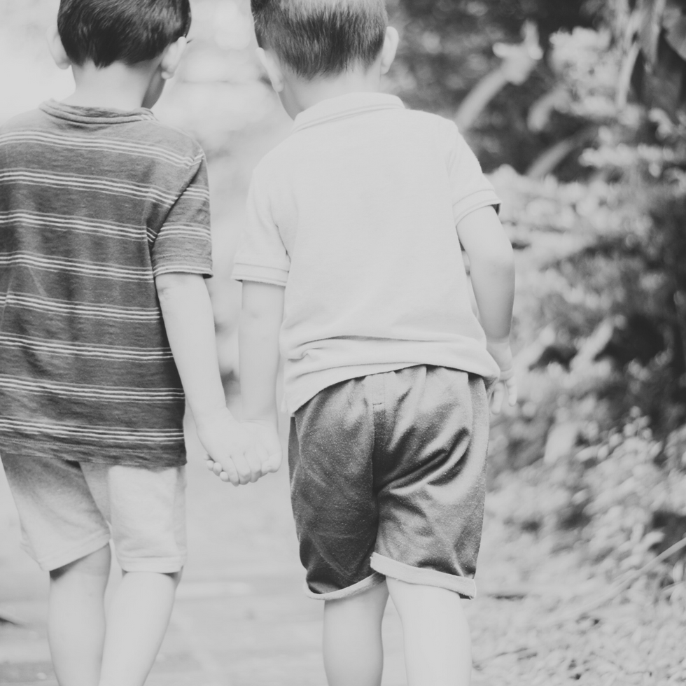 Two boys holding their hands