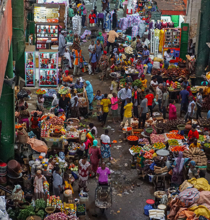 Eye-level view of a vibrant outdoor market with colorful stalls