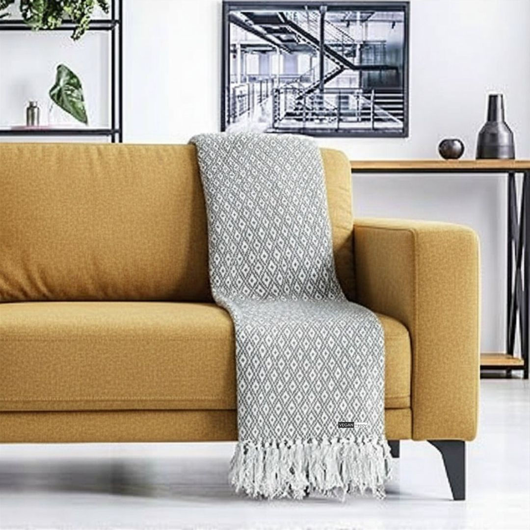 Vegan Scandi 100% Recycled Cotton Throw in silver on sofa with subtle vegan logo from Vegan Happy Clothing