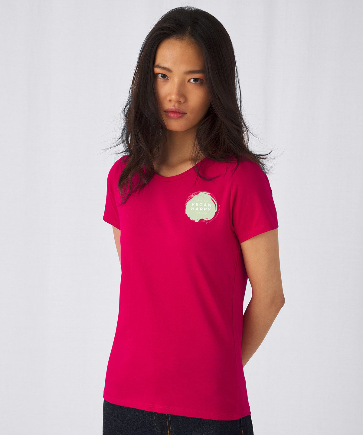 Vegan Happy Original Women's T-Shirt in pink from Vegan Happy Clothing showing front design on female model