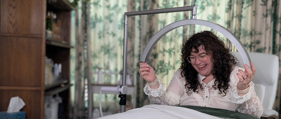 Amanda laughing beside her treatment bed at Amanda Hyde Skin