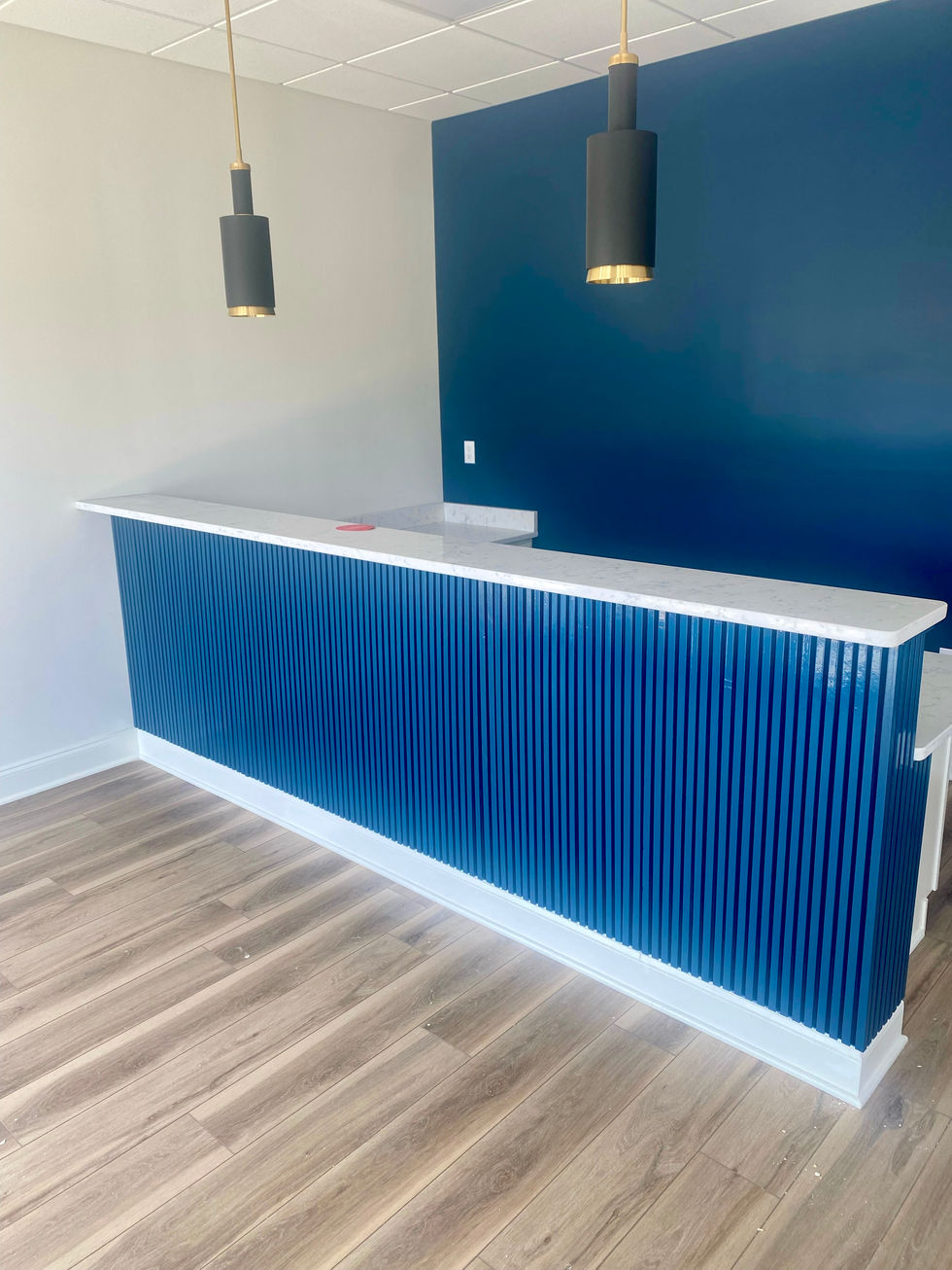 commercial interior receptionist desk after being painted blue