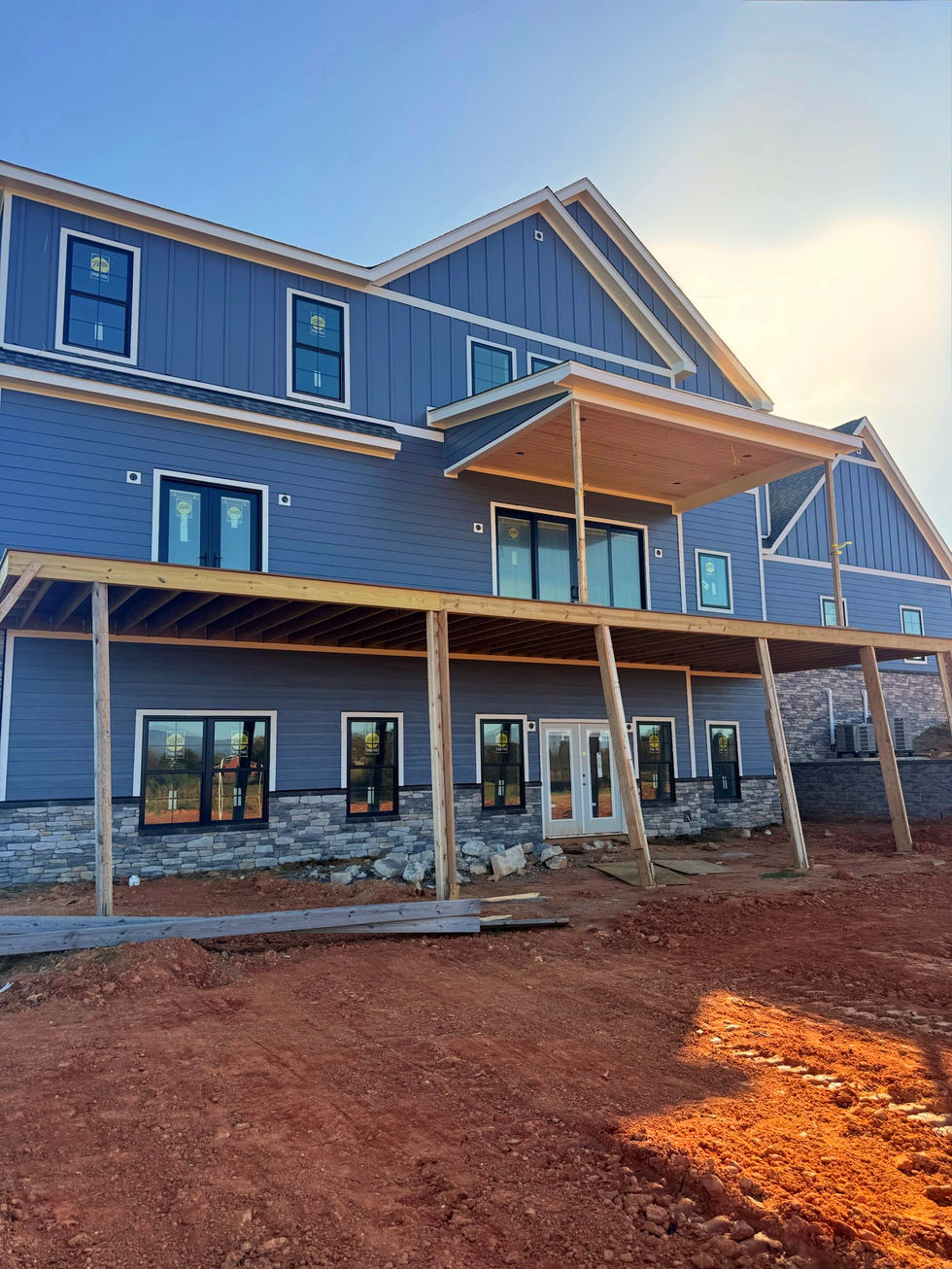 back exterior of a newly constructed home after being painted blue