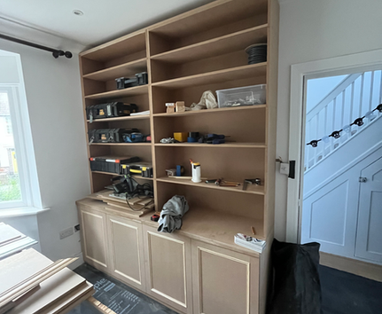 Bespoke alcove shelving and cabinet unit under construction in white painted finish by PK Decorating Wimbledon