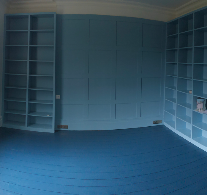 Room-wide built-in shelving painted in light blue by PK Decorating Wimbledon