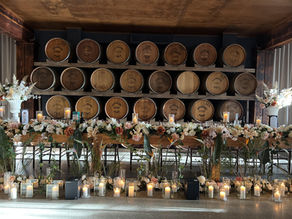 Winery rustic bridal table with wine barrel backdrop