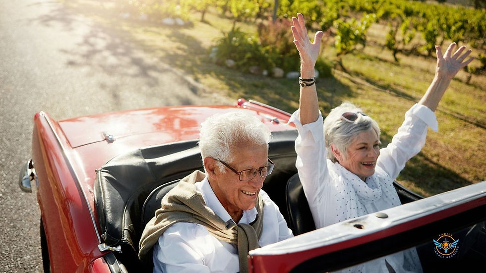 Retired couple driving a vintage red sport car