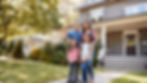 Family standing in front of their new home