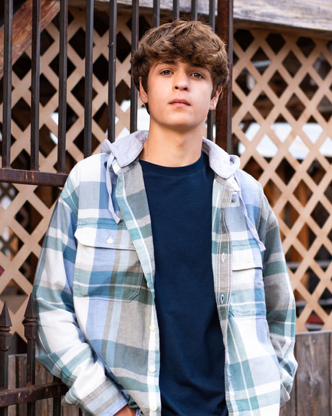 Senior portrait in a Casual look yet looking stylish in his plaid hooded shirt
