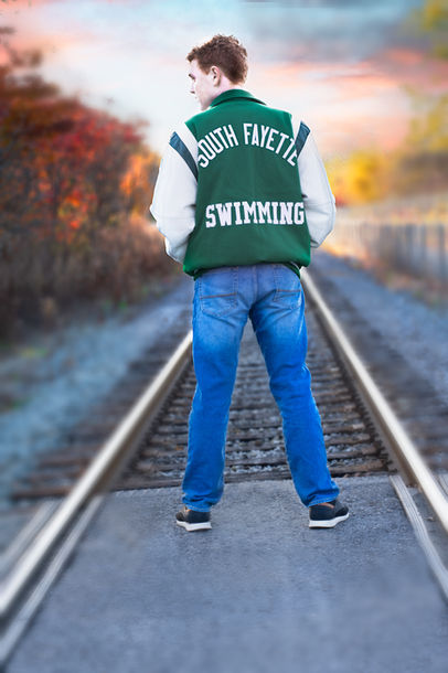 A Fine Art Senior Photo of a South Fayette senior at the golden hour by the rail tracks in Cecil Township
