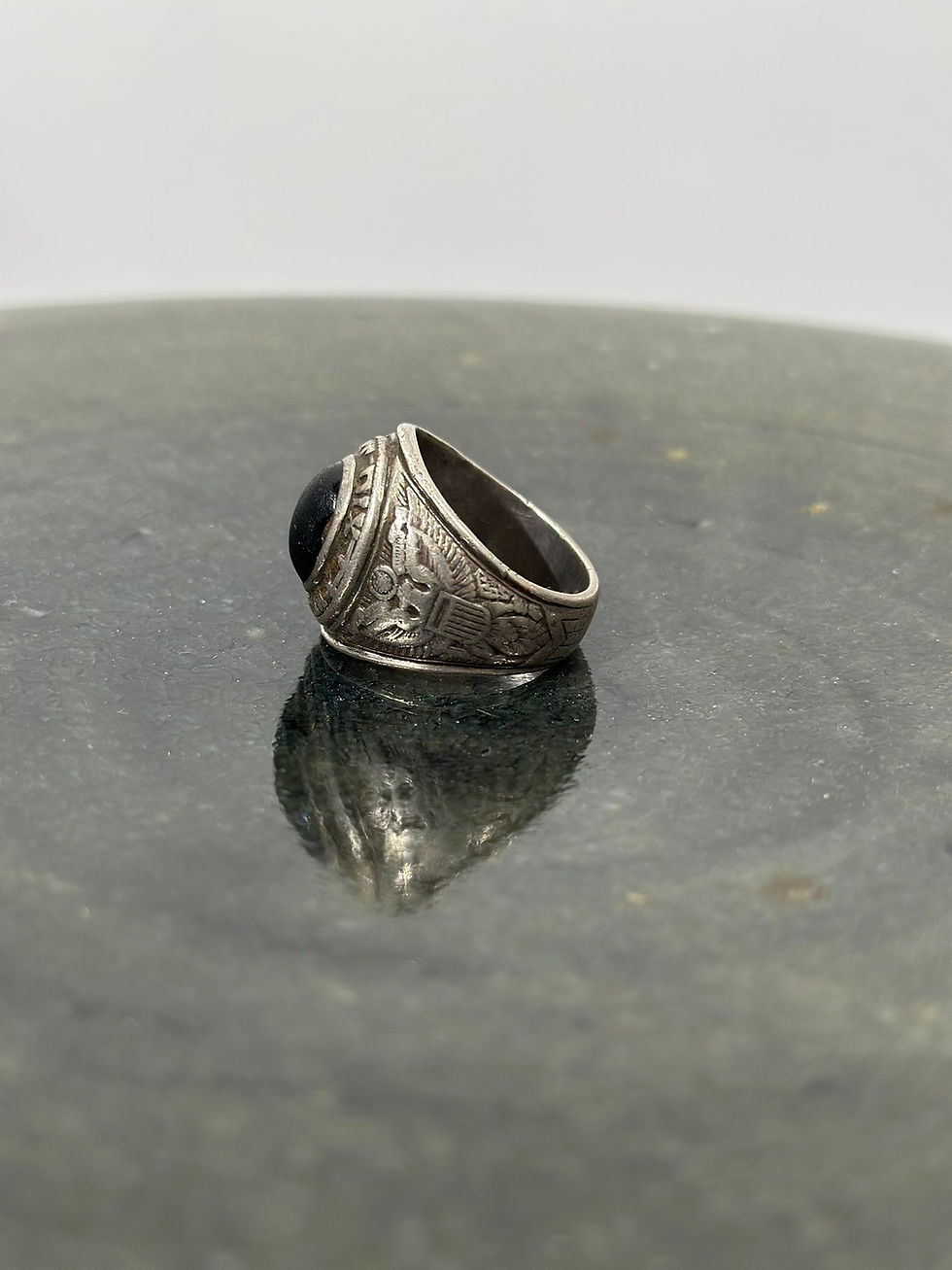 Thumbnail: Another side view of the 'face' of a WW2 US Tailor Made US Army Sterling Silver Ring featuring an oval black stone set in the centre. 