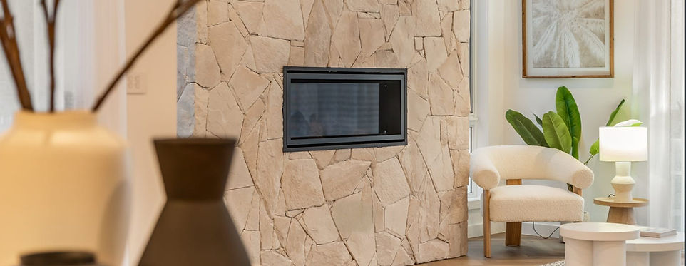 Professionally styled living space featuring natural stone textures, soft neutral furnishings and contemporary coastal styling