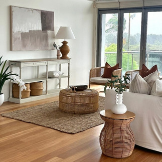 Lounge setting with timber and rattan settings and white lounge