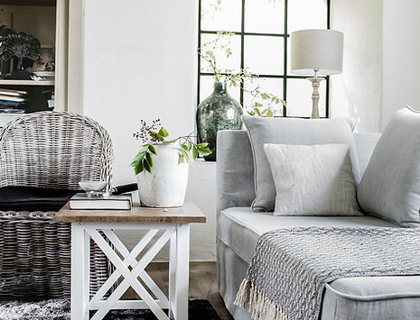 Loungeroom setting, using grey lounge, white timber side table and occasional chair by Home Property Styling in Copacabana Central Coast