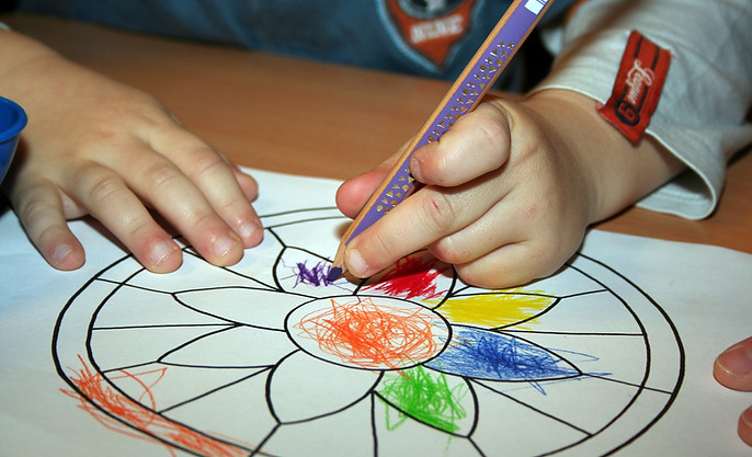 girl coloring a flower by amanda fernando