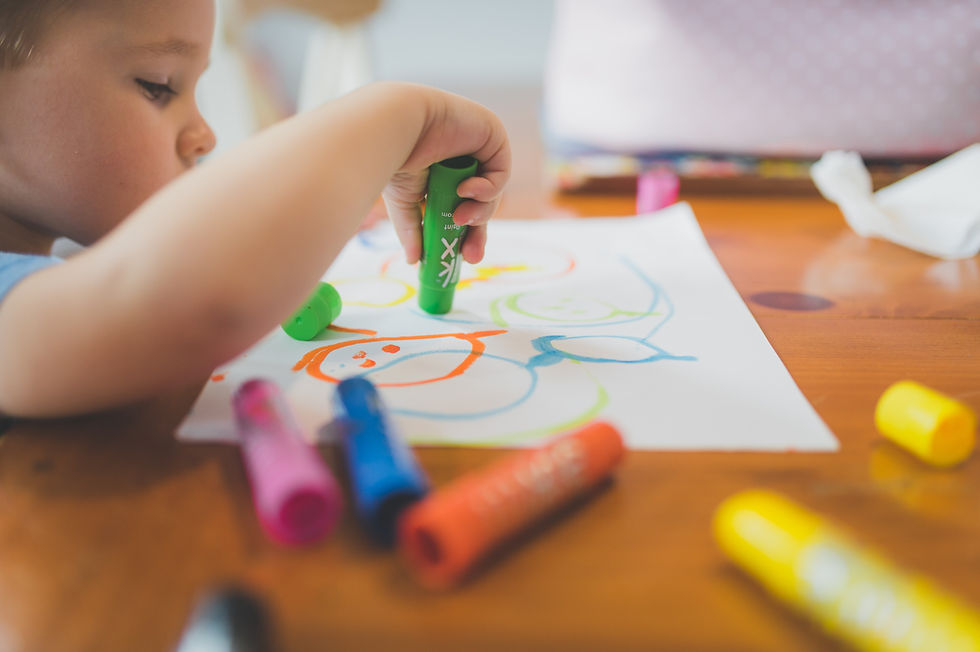 child-coloring-on-table-by-nalaka-daundaratne
