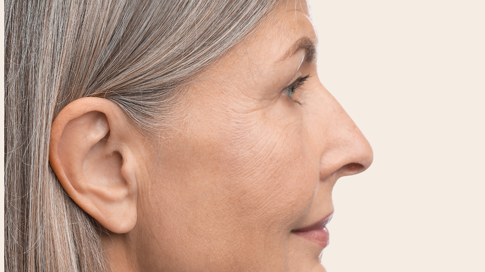 Woman side on with grey hair and close up of skin