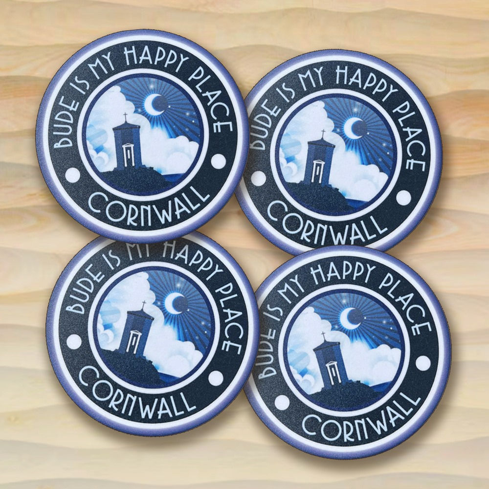 Four round coasters. The text on each reads "BUDE IS MY HAPPY PLACE CORNWALL," highlighting the location as a beloved spot.