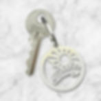 Bude Sunbeam stainless steel keyring inspired by coastal sunbeams and Budeful logo, handmade in Cornwall