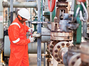 Engineer assessing oil and gas plant