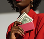 black woman holding a pink wallet with money