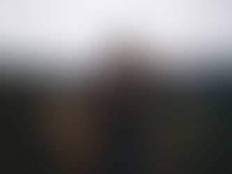 a couple kissing and hugging on a mountain top