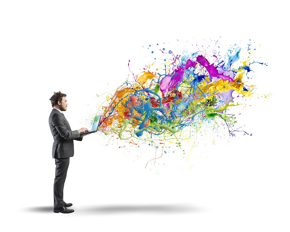 Colors emerge from the laptop of a creative businessman.