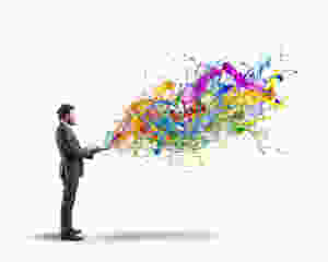 Colors emerge from the laptop of a creative businessman.