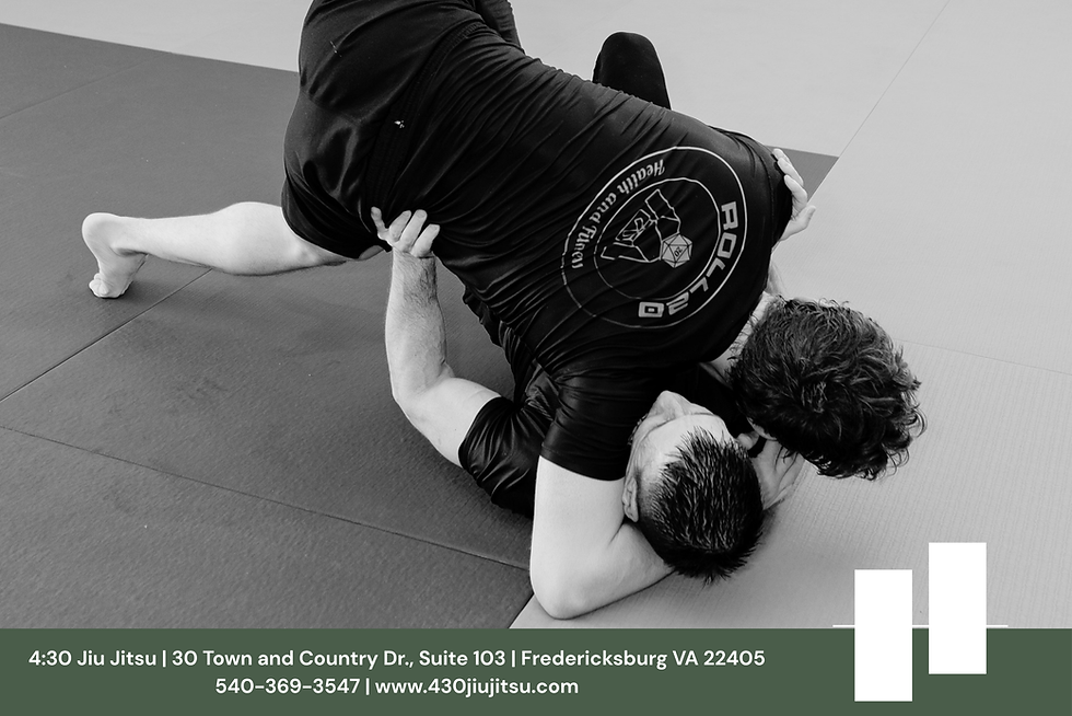 Two adults practicing no-gi jiu jitsu on the mats at 4:30 Jiu Jitsu in Fredericksburg, Virginia, illustrating decision-making under pressure.