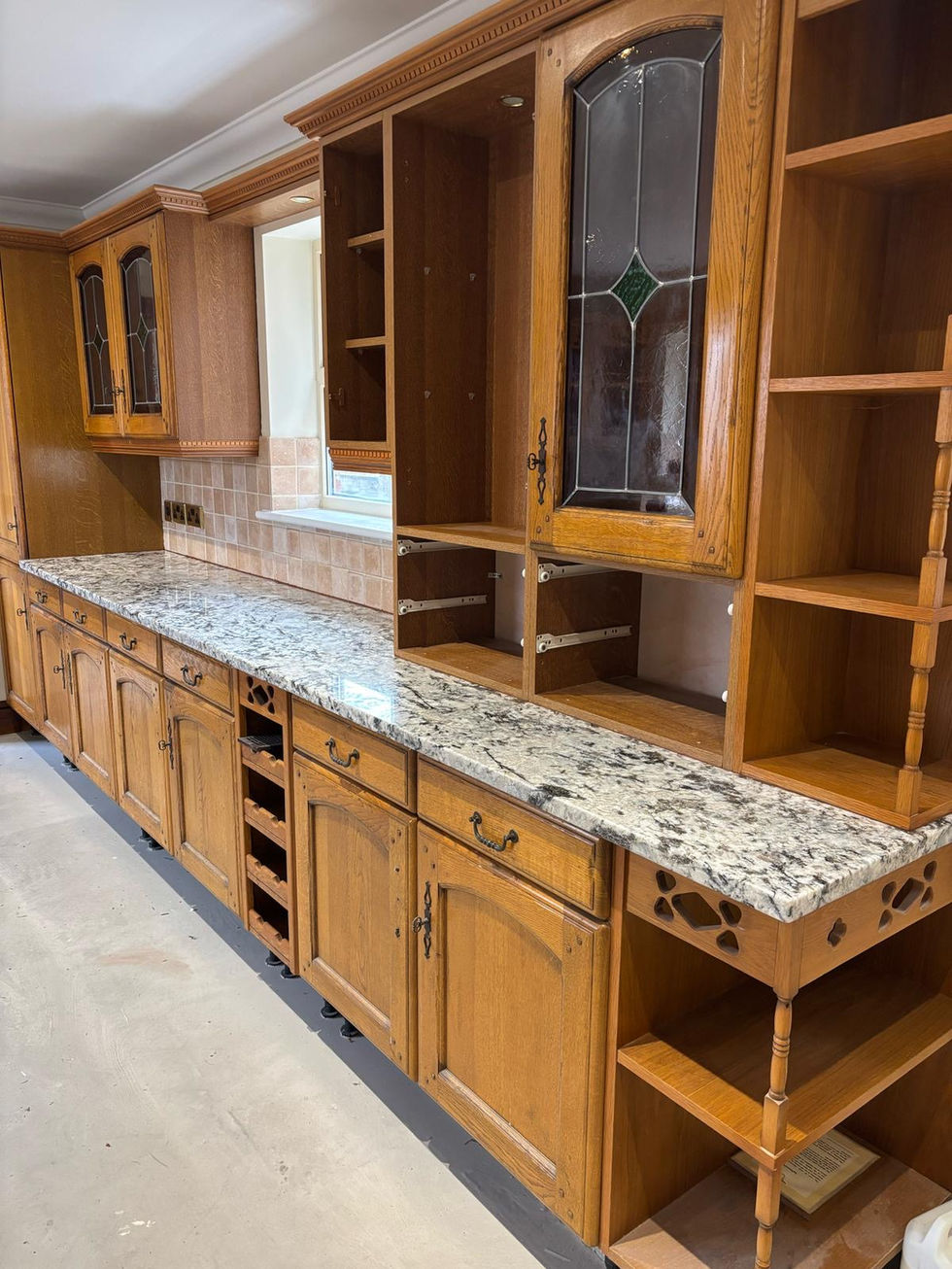 a kitchen with wooden cabinets and granite counter tops