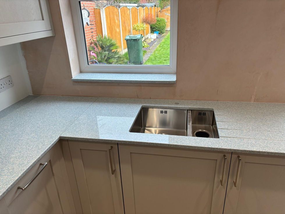 Shown with a undermounted sink cut out, tap hole, drainer grooves & a window sill