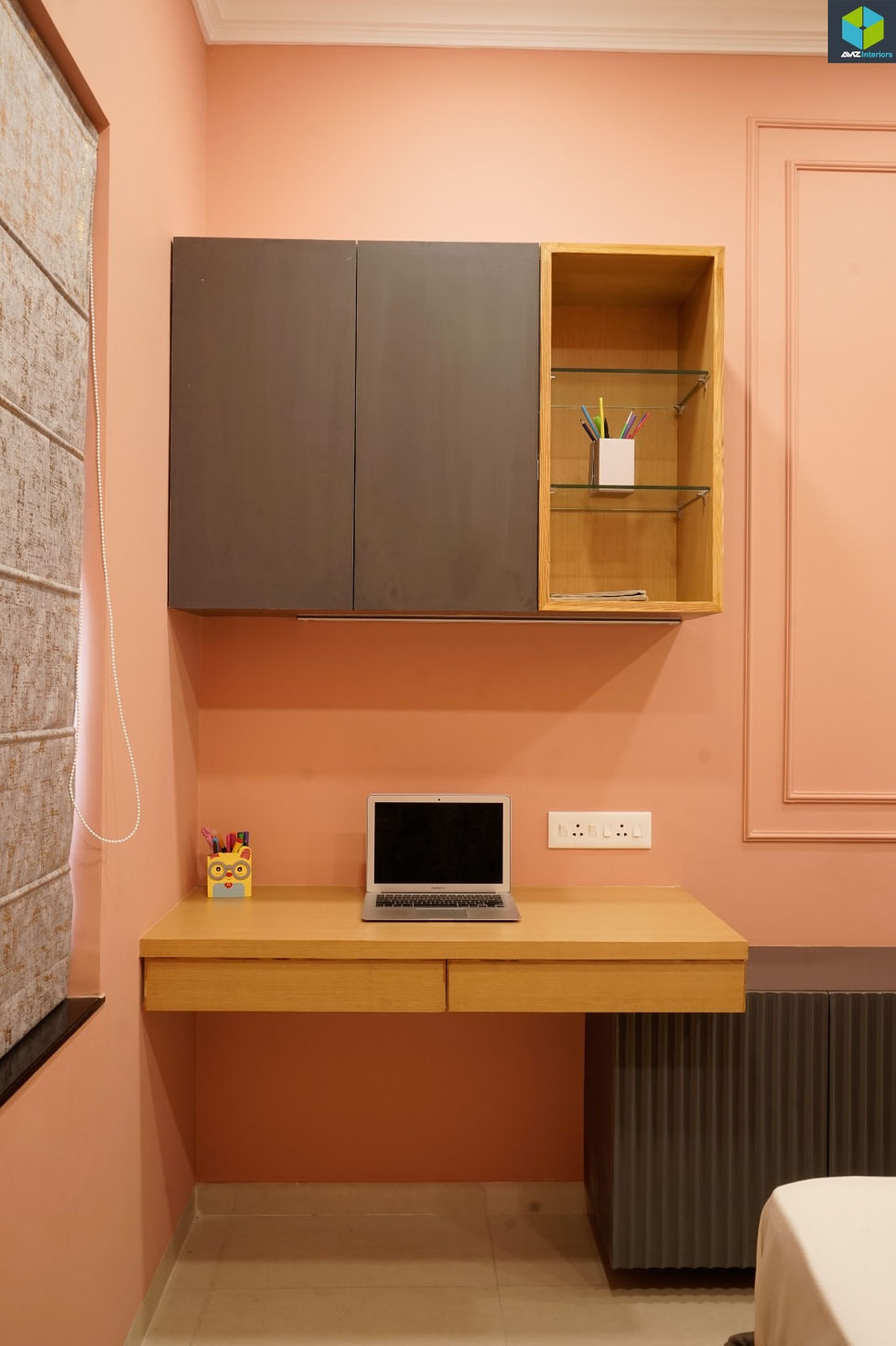 Modern guest bedroom with peach and grey interiors designed by AMZ Interiors for Dr. Juhi Luthra's bungalow.
