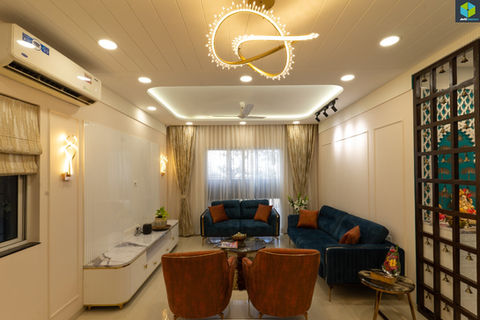 uxury living room with bespoke PU-finished white furniture and blue accents designed by AMZ Interiors for Dr. Juhi Luthra in Pune.