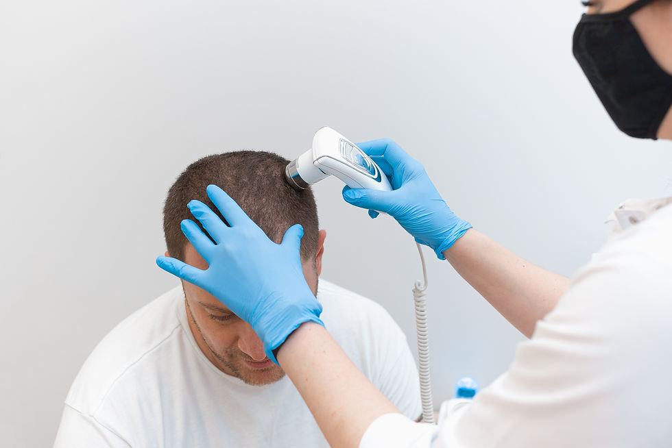 Hair transplant consultation: doctor examines patient's scalp