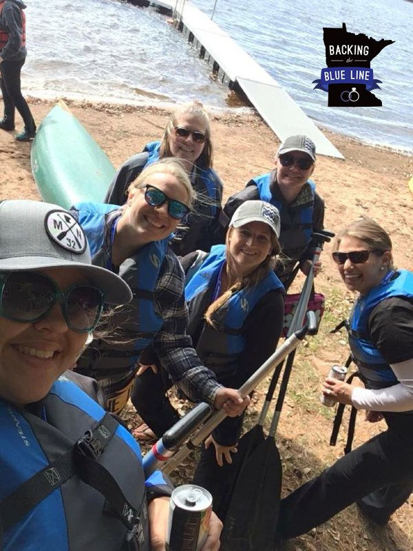 A group of six police wives getting ready to canoe on the lake