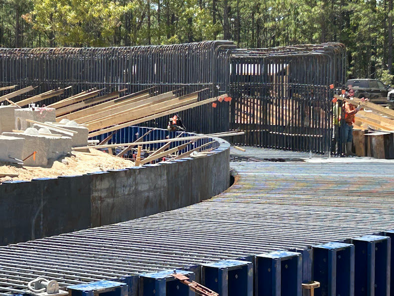 Workers constructing circular concrete structure