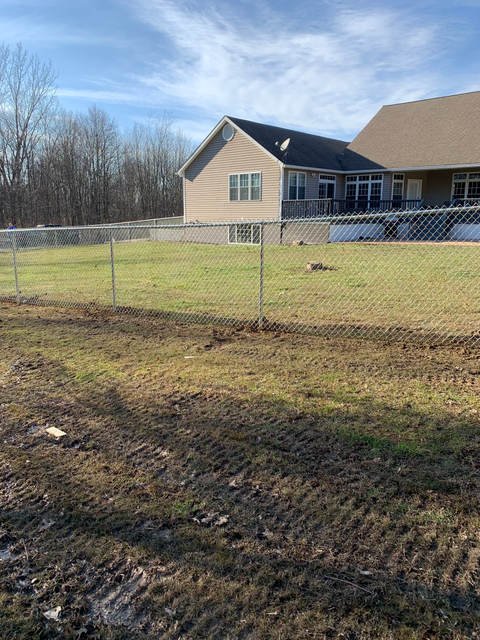 Chain link fence installed around house
