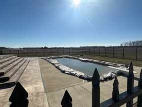 Winterized in-ground pool with fence