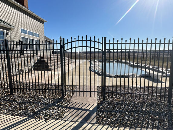 Black aluminum fence gate and pool
