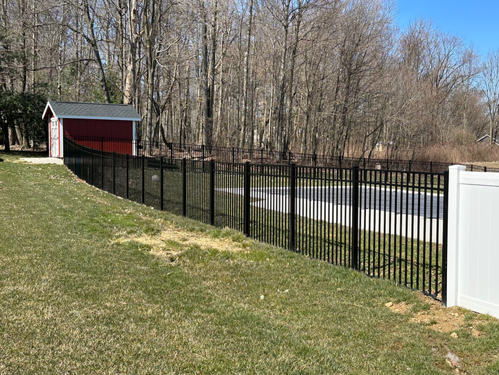 Black aluminum fence around pool area