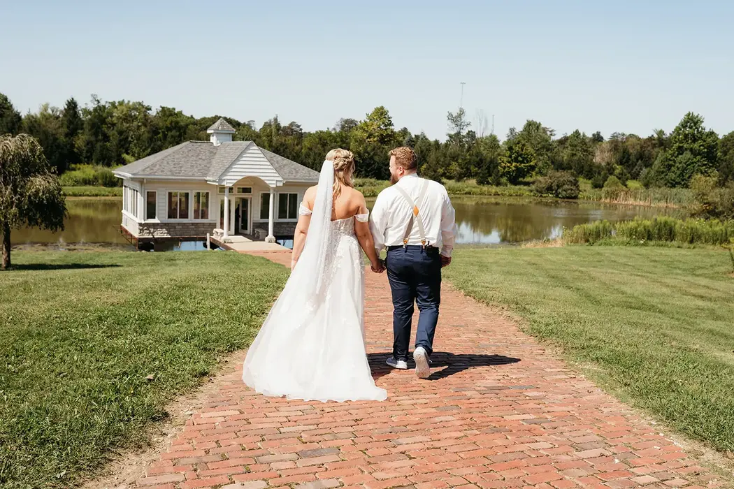 Bride and groom walking away at Union Manor Conservatory