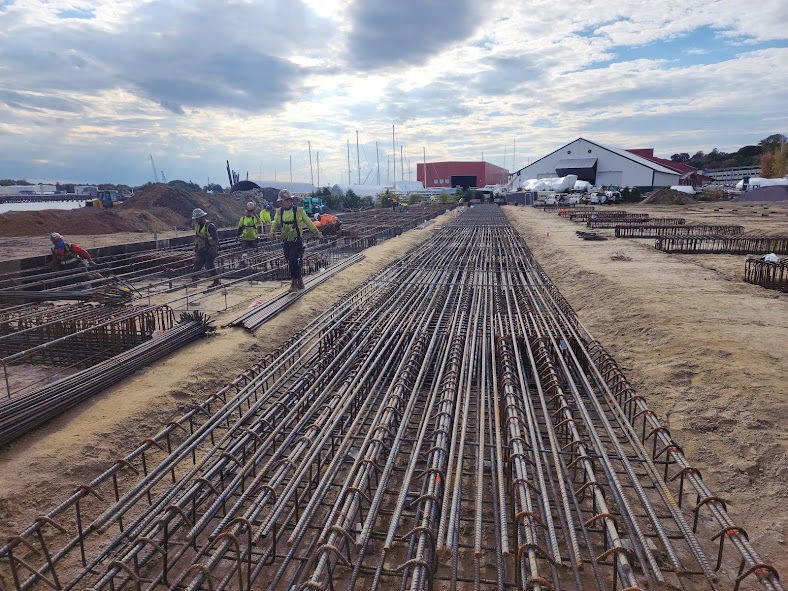 Construction workers preparing rebar for foundation