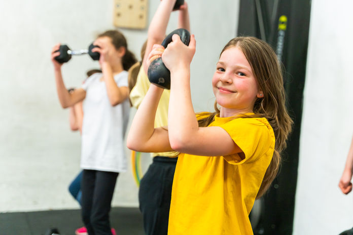 female student lifting a kettleball