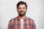 Smiling man in red plaid shirt