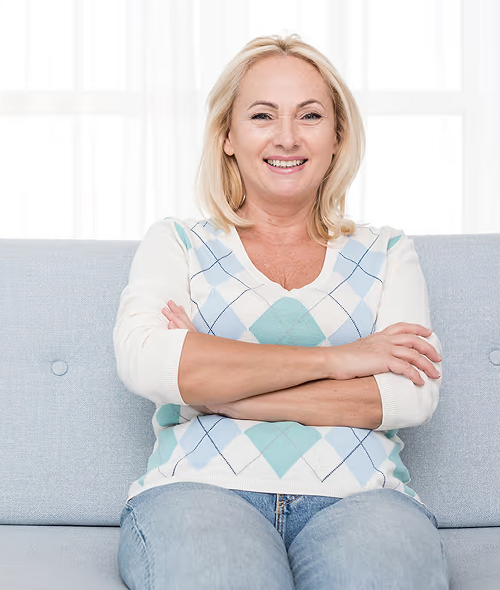 Smiling woman sitting on couch, arms crossed