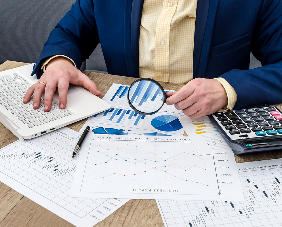 Businessperson analyzes financial charts with magnifying glass