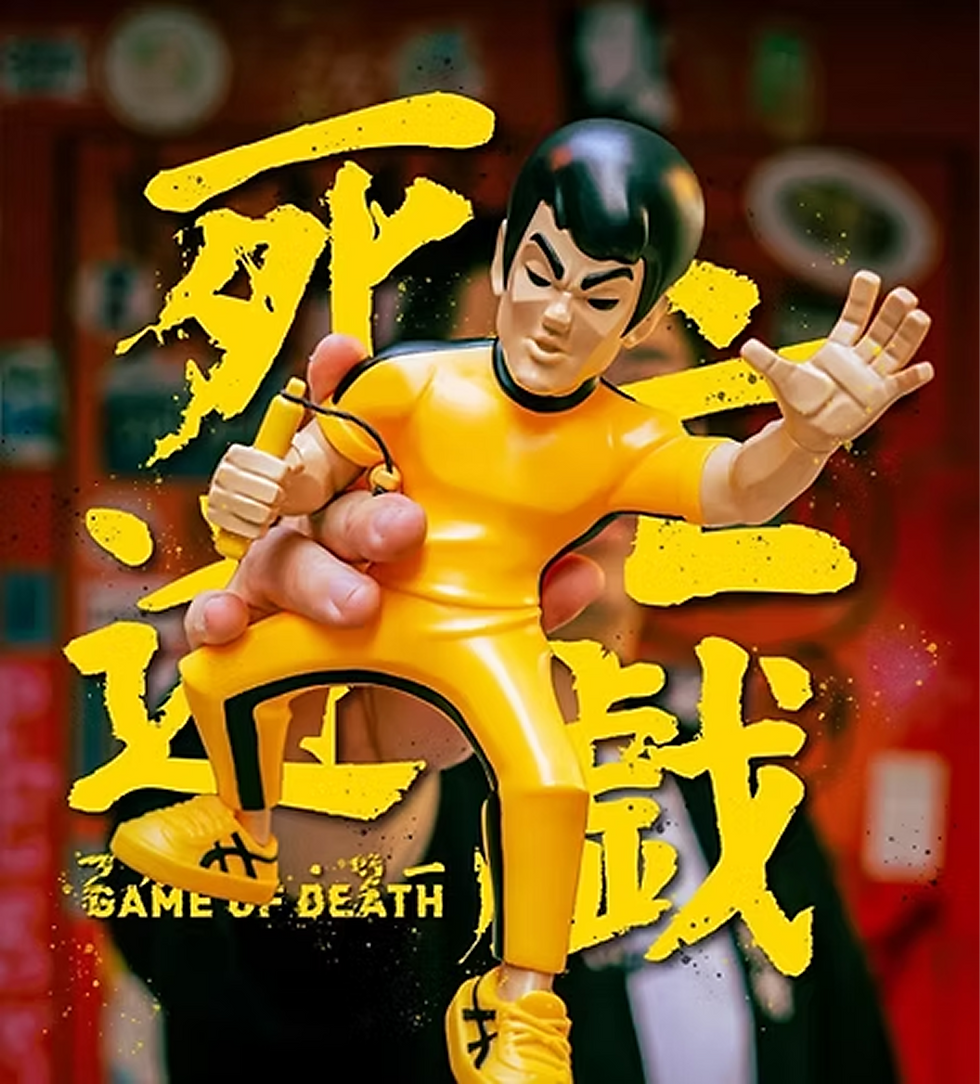 Bruce Lee figure in yellow suit with nunchaku, Game of Death
